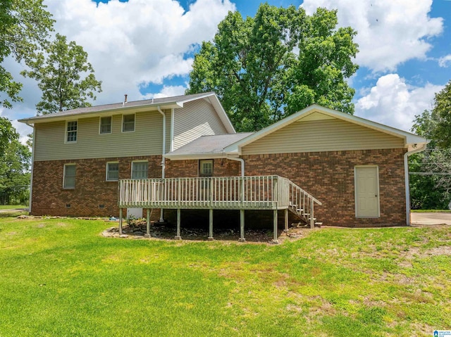 994 Comanche Trl, Anniston, AL 36206 - back of house featuring brick siding, a wooden deck, a yard, crawl space, and stairway