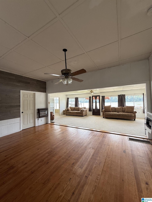 829 Higgs Dr, Adger, AL 35006 - unfurnished living room featuring a ceiling fan, healthy amount of natural light, hardwood / wood-style floors, and wooden walls