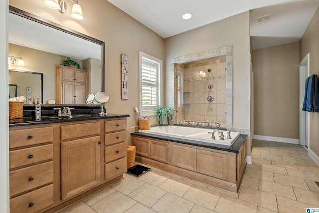 bathroom featuring vanity, a bath, tiled shower, tile patterned floors, and baseboards