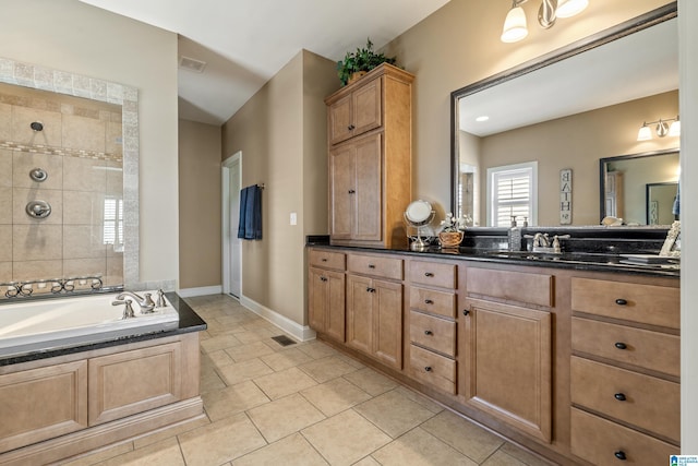 bathroom with vanity, tile patterned floors, a garden tub, tiled shower, and baseboards