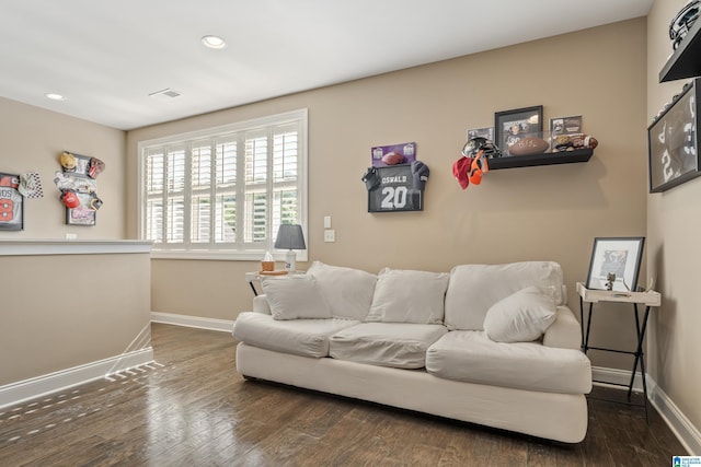 living room with baseboards, wood finished floors, and recessed lighting