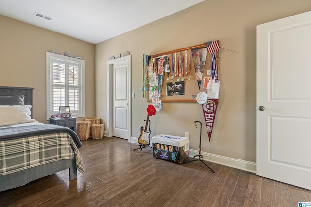 bedroom featuring wood finished floors and baseboards