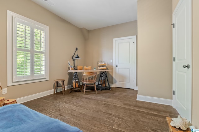 bedroom featuring wood finished floors and baseboards