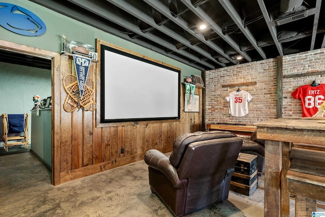 cinema with unfinished concrete flooring and wood walls
