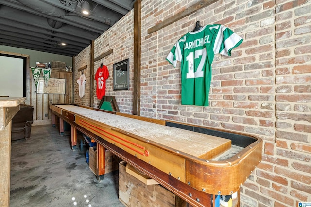 playroom featuring unfinished concrete flooring
