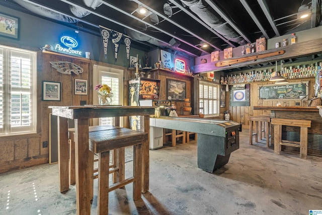 playroom featuring concrete floors and a dry bar