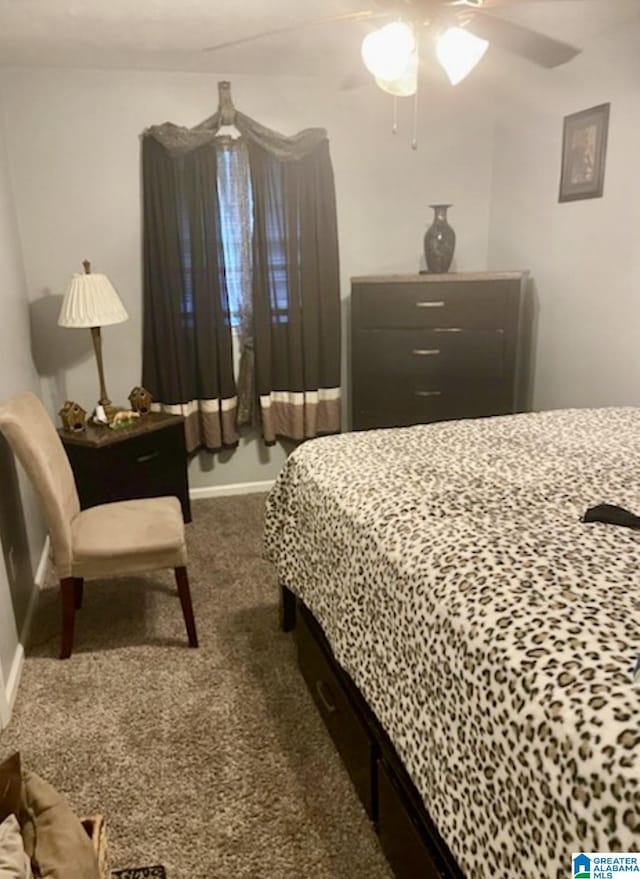 906 30th St, Phenix City, AL 36867 - bedroom with dark colored carpet, ceiling fan, and baseboards