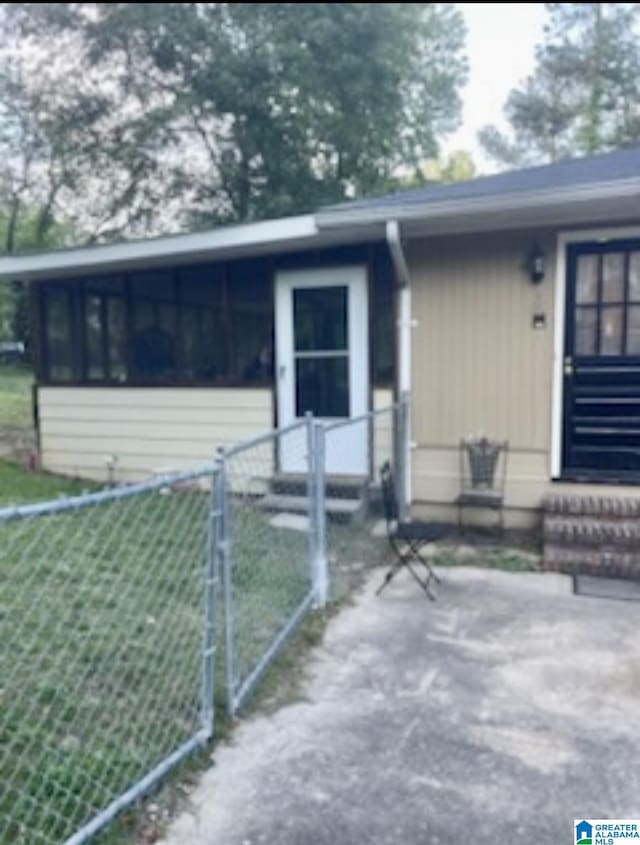 906 30th St, Phenix City, AL 36867 - view of property exterior featuring a fenced front yard, entry steps, and a gate