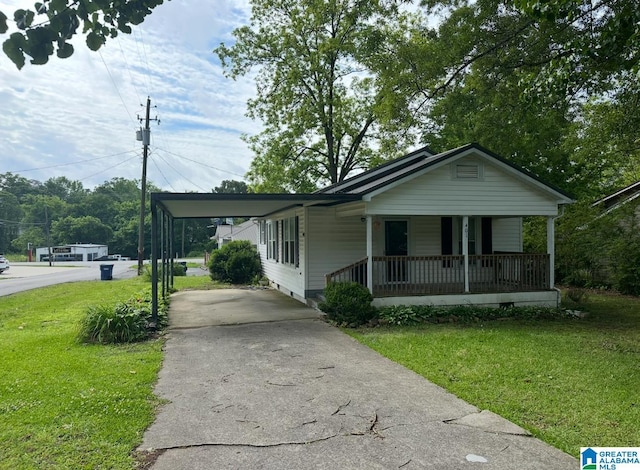 401 W 3rd Ave, Oneonta, AL 35121 - view of front of home with a porch, a front yard, concrete driveway, crawl space, and an attached carport