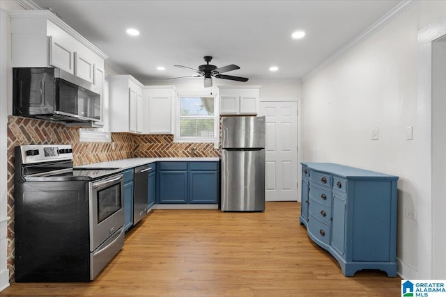 401 W 3rd Ave, Oneonta, AL 35121 - kitchen with stainless steel appliances, blue cabinets, crown molding, white cabinetry, and ceiling fan