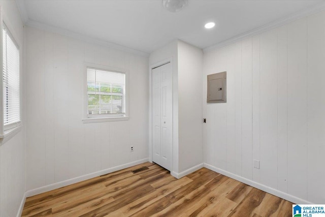 401 W 3rd Ave, Oneonta, AL 35121 - empty room with electric panel, light wood finished floors, baseboards, and crown molding
