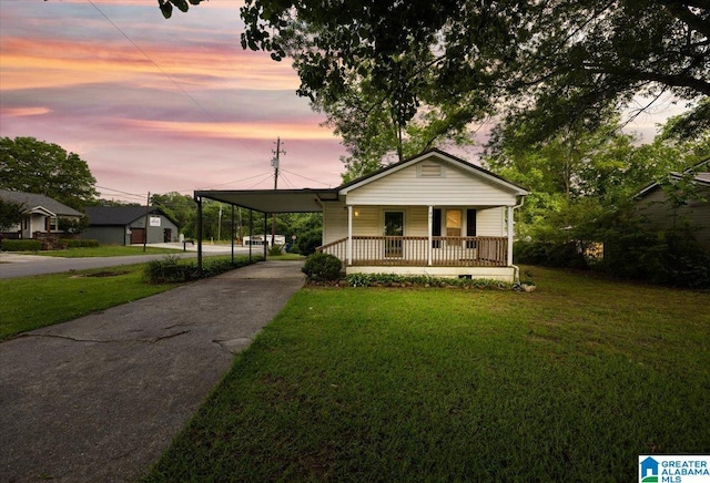 401 W 3rd Ave, Oneonta, AL 35121 - view of front of house with covered porch, a front yard, driveway, and an attached carport