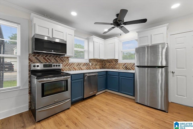 401 W 3rd Ave, Oneonta, AL 35121 - kitchen featuring stainless steel appliances, blue cabinets, white cabinets, crown molding, and healthy amount of natural light