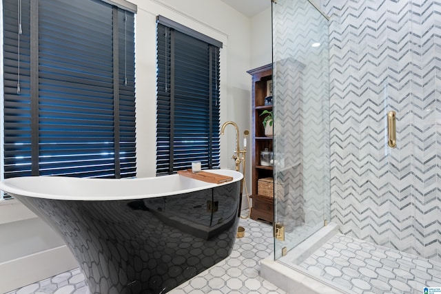 full bathroom featuring a stall shower and a soaking tub