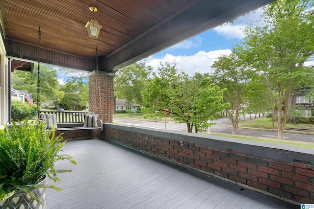 wooden terrace featuring a porch