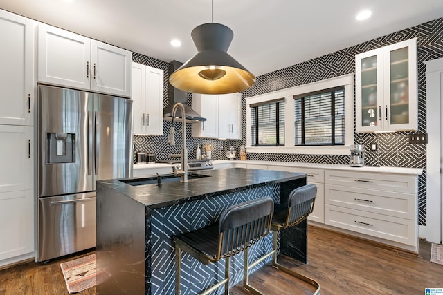 kitchen with stainless steel fridge with ice dispenser, white cabinets, decorative backsplash, and recessed lighting