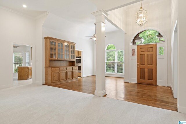 175 Sunhill Rd, Remlap, AL 35133 - carpeted foyer entrance featuring a high ceiling, ceiling fan, a chandelier, baseboards, and decorative columns