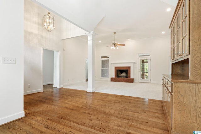 175 Sunhill Rd, Remlap, AL 35133 - unfurnished living room featuring ceiling fan, baseboards, ornate columns, light wood-type flooring, and a brick fireplace