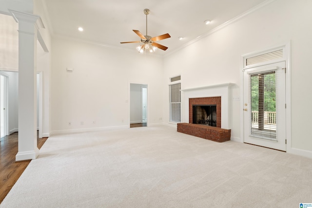 175 Sunhill Rd, Remlap, AL 35133 - unfurnished living room featuring crown molding, a ceiling fan, baseboards, a towering ceiling, and a fireplace