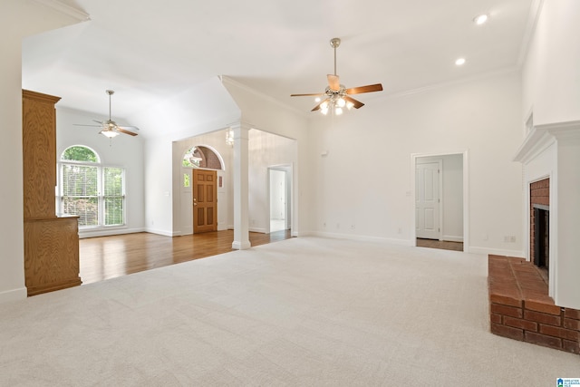 175 Sunhill Rd, Remlap, AL 35133 - unfurnished living room featuring ceiling fan, carpet floors, ornate columns, a fireplace, and ornamental molding