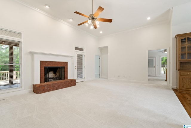 175 Sunhill Rd, Remlap, AL 35133 - unfurnished living room featuring a ceiling fan, a high ceiling, plenty of natural light, a brick fireplace, and ornamental molding