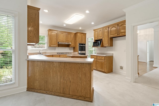 175 Sunhill Rd, Remlap, AL 35133 - kitchen with stainless steel appliances, a sink, a peninsula, under cabinet range hood, and light countertops