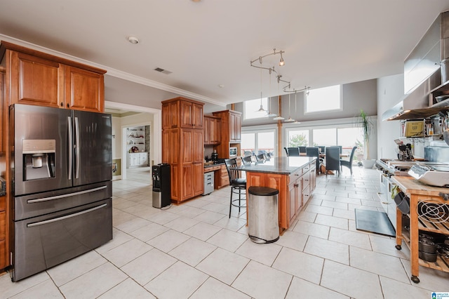 327 Ridgeview Lake Rd, Alabaster, AL 35007 - kitchen featuring stainless steel fridge, a kitchen bar, a center island, brown cabinetry, and crown molding