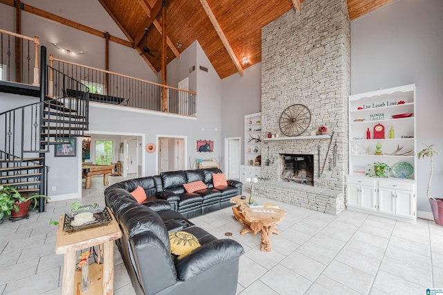 327 Ridgeview Lake Rd, Alabaster, AL 35007 - tiled living area with wood ceiling, high vaulted ceiling, stairs, a fireplace, and beam ceiling