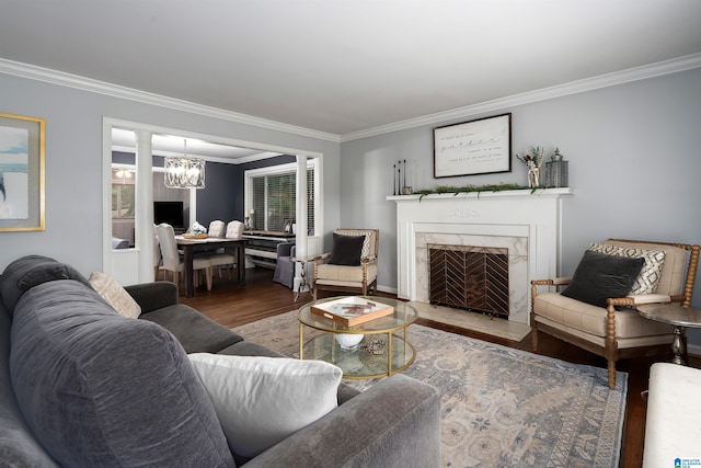 734 Crest Ln, Homewood, AL 35209 - living room featuring wood finished floors, crown molding, a high end fireplace, a chandelier, and baseboards