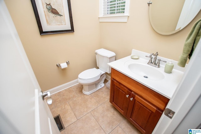 half bath featuring vanity, baseboards, toilet, and tile patterned floors