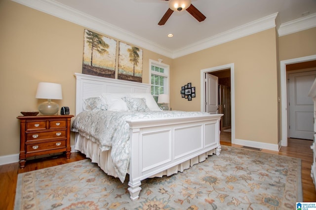 bedroom with crown molding, light wood finished floors, baseboards, and ceiling fan