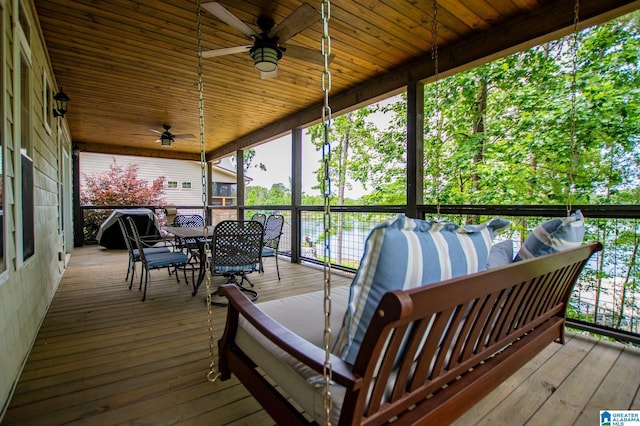 wooden terrace featuring a ceiling fan and outdoor dining space