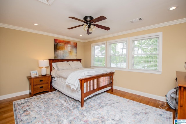 bedroom with baseboards, ornamental molding, wood finished floors, recessed lighting, and a ceiling fan