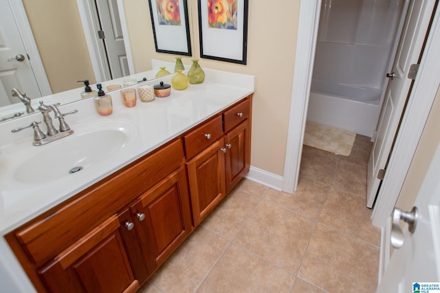 bathroom with vanity, tile patterned floors, and baseboards