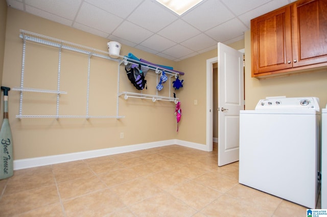 laundry room with washer / dryer, cabinet space, light tile patterned floors, and baseboards