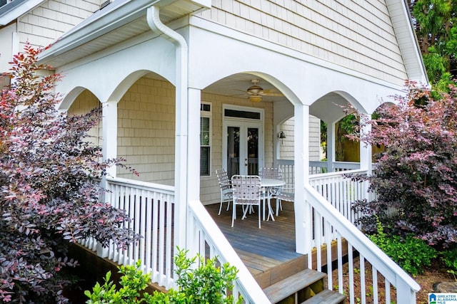 wooden terrace with a porch and french doors