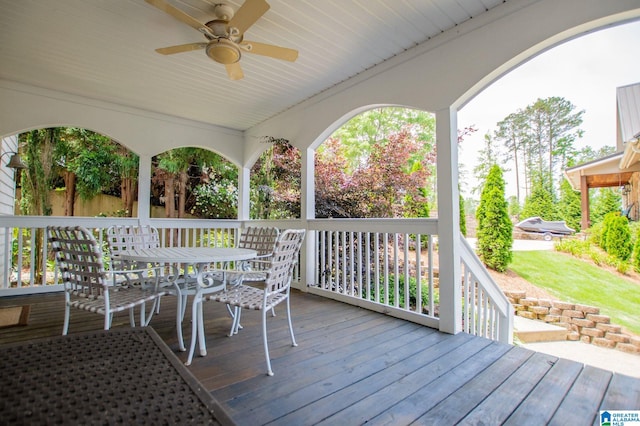 wooden deck featuring a ceiling fan and outdoor dining space