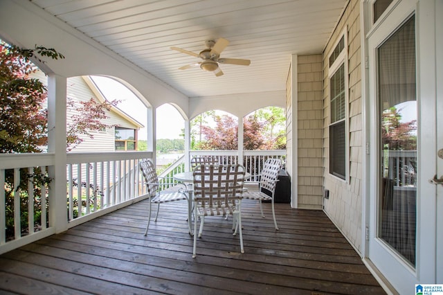 wooden terrace featuring a ceiling fan