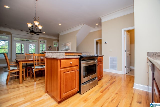 kitchen with crown molding, a chandelier, light wood finished floors, brown cabinetry, and pendant lighting