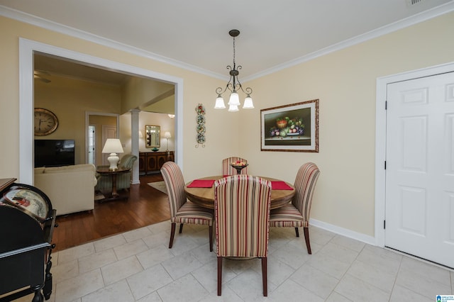 dining space featuring ornate columns, ornamental molding, baseboards, and light tile patterned floors