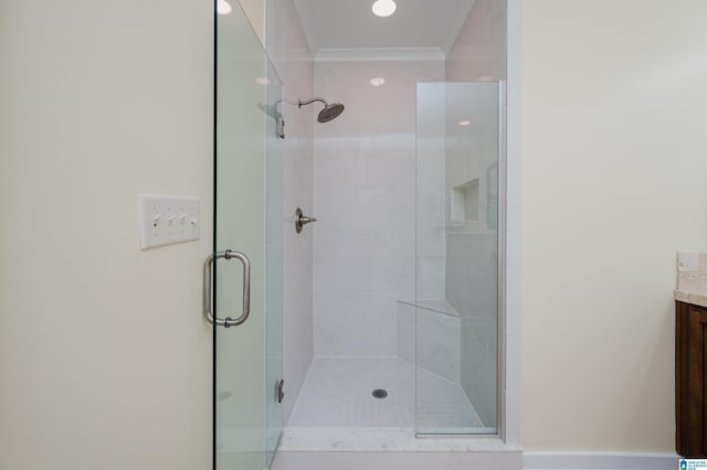 full bath featuring a stall shower, vanity, and ornamental molding