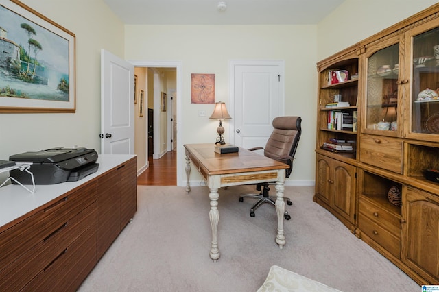 office featuring light carpet and baseboards