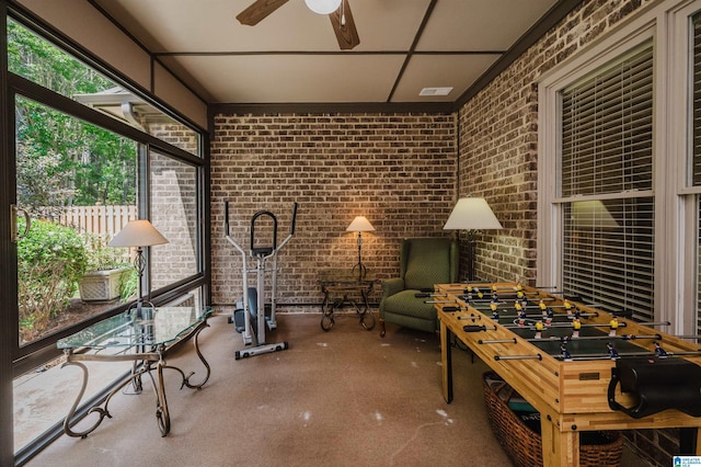 sunroom featuring a ceiling fan