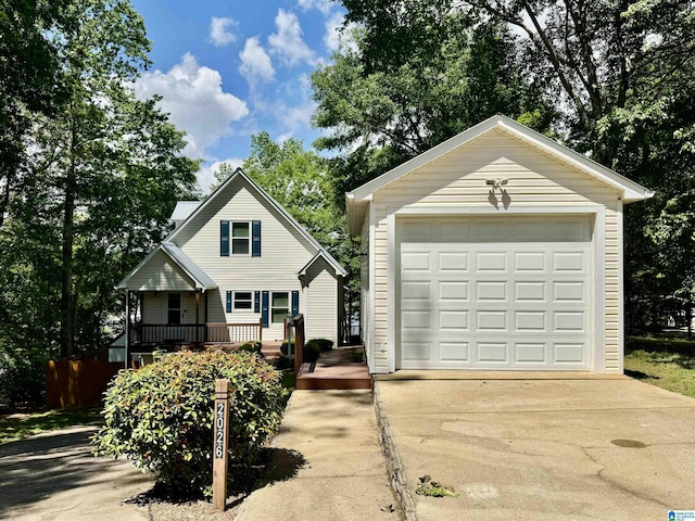 view of front of house with driveway, a detached garage, and an outdoor structure