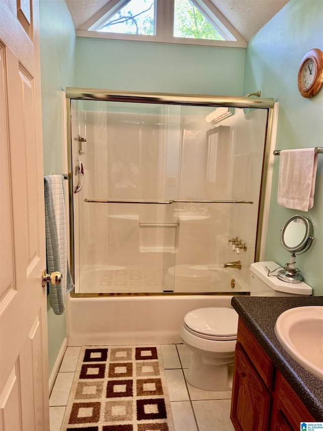 full bath featuring vaulted ceiling, tile patterned floors, bath / shower combo with glass door, toilet, and vanity
