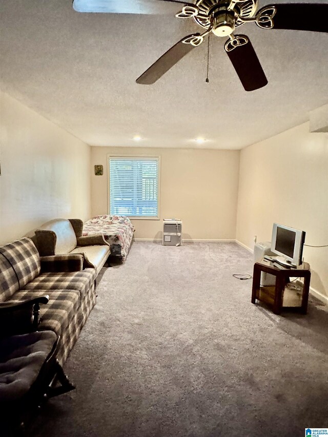 unfurnished living room featuring a ceiling fan, carpet floors, and baseboards