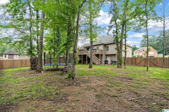 984 Knobloch Ln, Moody, AL 35004 - fenced backyard with a trampoline, stairway, and a wooden deck