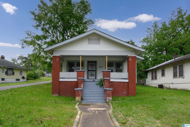 view of front of home with a front lawn, covered porch, and central AC unit