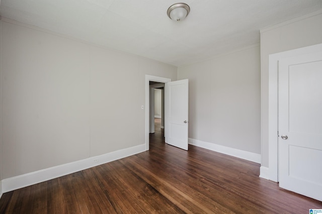 unfurnished bedroom featuring dark wood-style flooring and baseboards