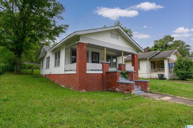 bungalow-style home with a porch and a front yard